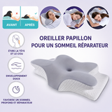 Oreiller cervical en forme papillon gris, base blanche texturée, vue en biais