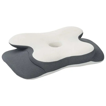 Oreiller cervical ergonomique en mousse à mémoire, blanc et gris, forme sculptée.
